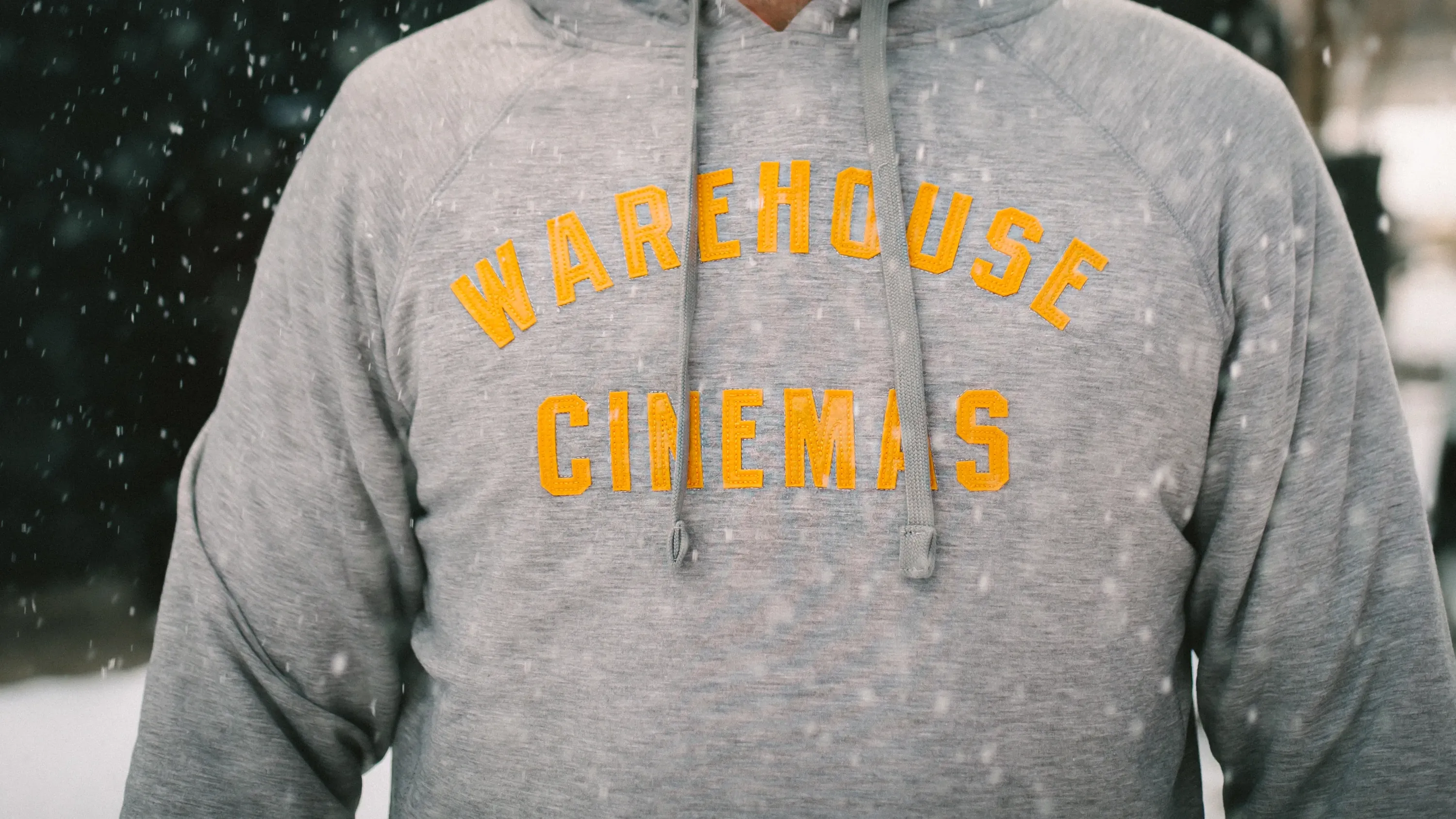 Warehouse Cinemas Heather Gray Sewn Lettering Accent Stitching Woven Interior Label Screen Printed Interior Taping Woven Clamp Tag Custom Pullover Hoodie by Anthem Branding