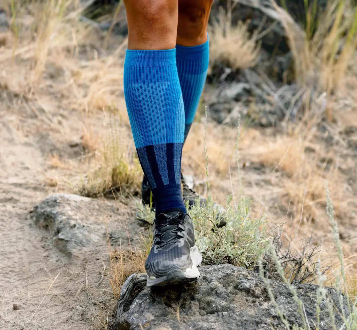 Hiker wearing merino wool compression socks on trail