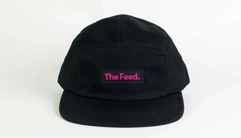 The Feed Camper Hat Black Pink Logo Patch by Anthem Branding