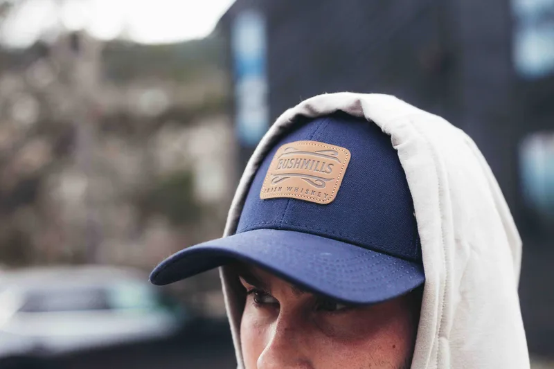 Debossed leather patchembroidered twill patch w merrowed edge detail by anthem branding 1